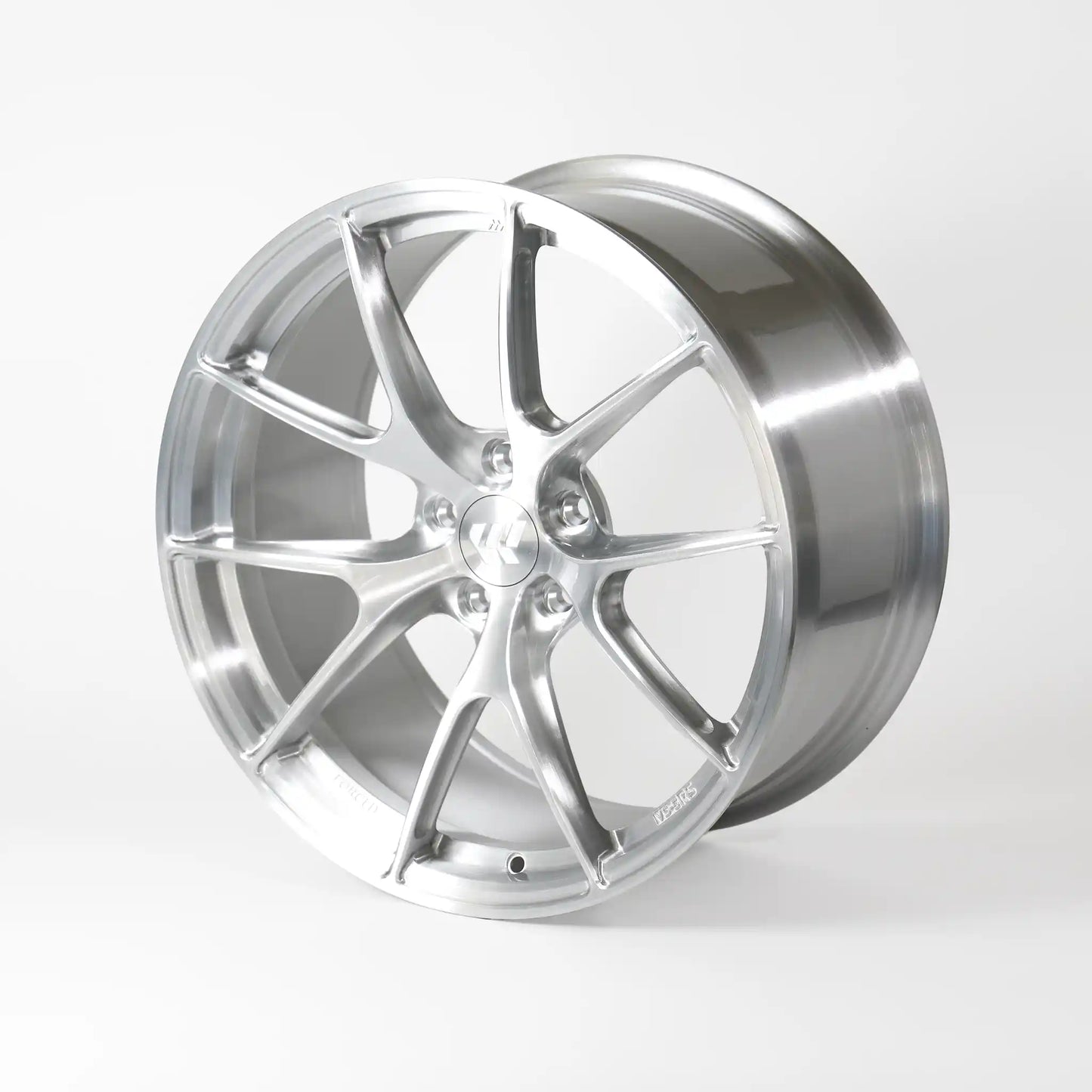A polished silver alloy wheel rim with a multi-spoke design, photographed on a seamless light gray studio background.