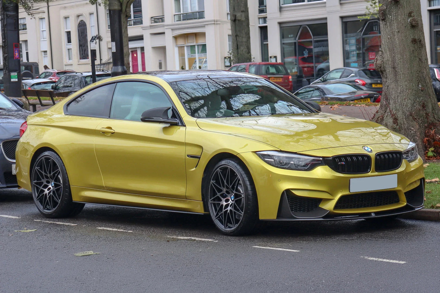 BMW F82 M4 Coupe in Austin Yellow equipped with aftermarket performance wheels