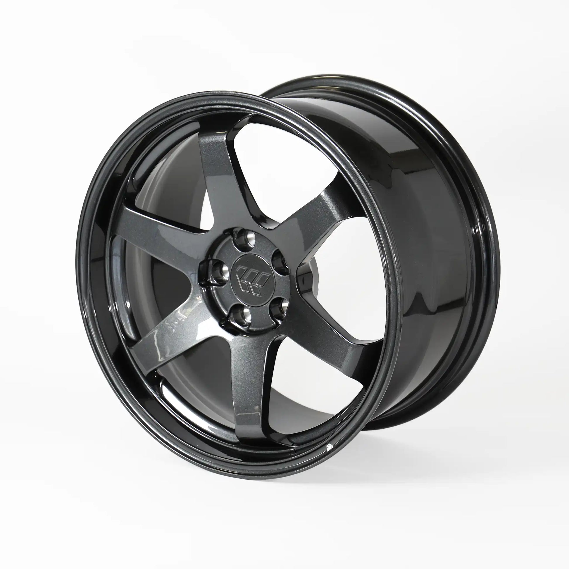 A glossy black multi-spoke alloy wheel rim, photographed at a three-quarter angle on a clean white studio background.