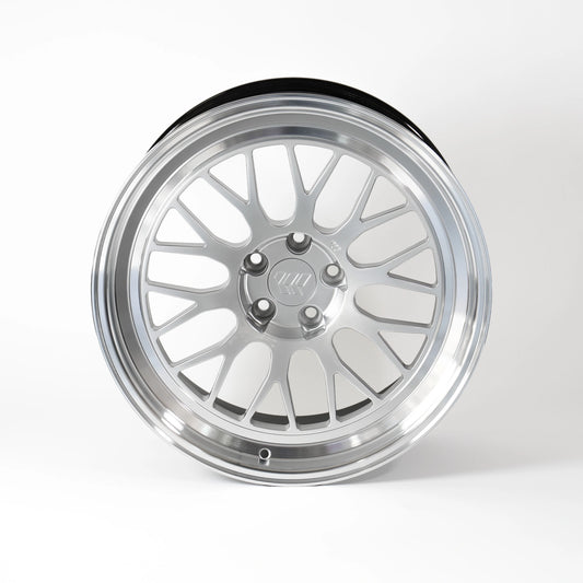 A polished silver multi-spoke alloy wheel rim with a black outer tire bead, shown from a three-quarters perspective on a light gray background.