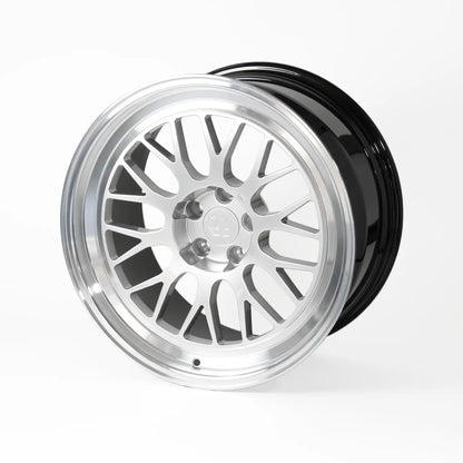 A multi-spoke alloy wheel rim with a polished silver finish and a glossy black outer barrel, shown on a light gray studio background.