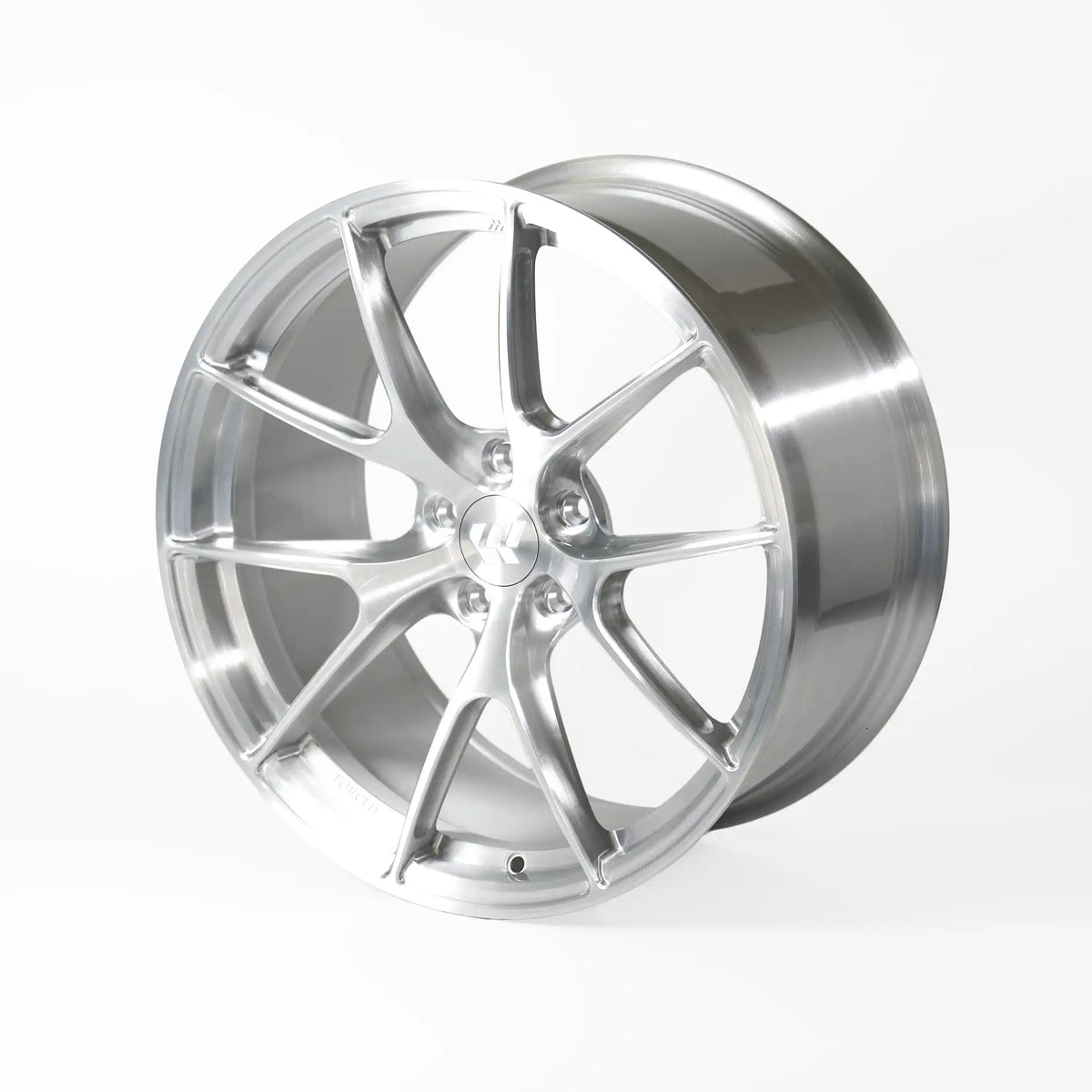 A polished silver alloy car wheel rim with a multi-spoke design, shown at a three-quarter angle on a light gray studio background.