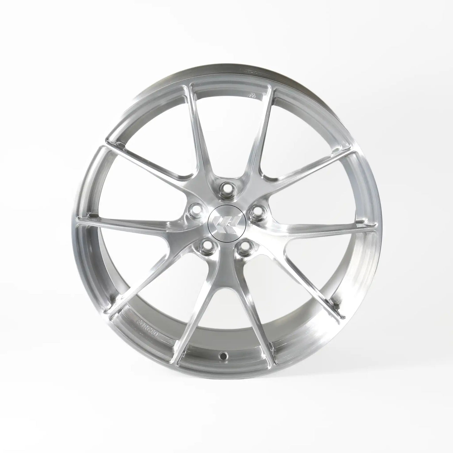 A polished silver multi-spoke alloy wheel rim, photographed from a front-three-quarter angle on a clean white studio background.
