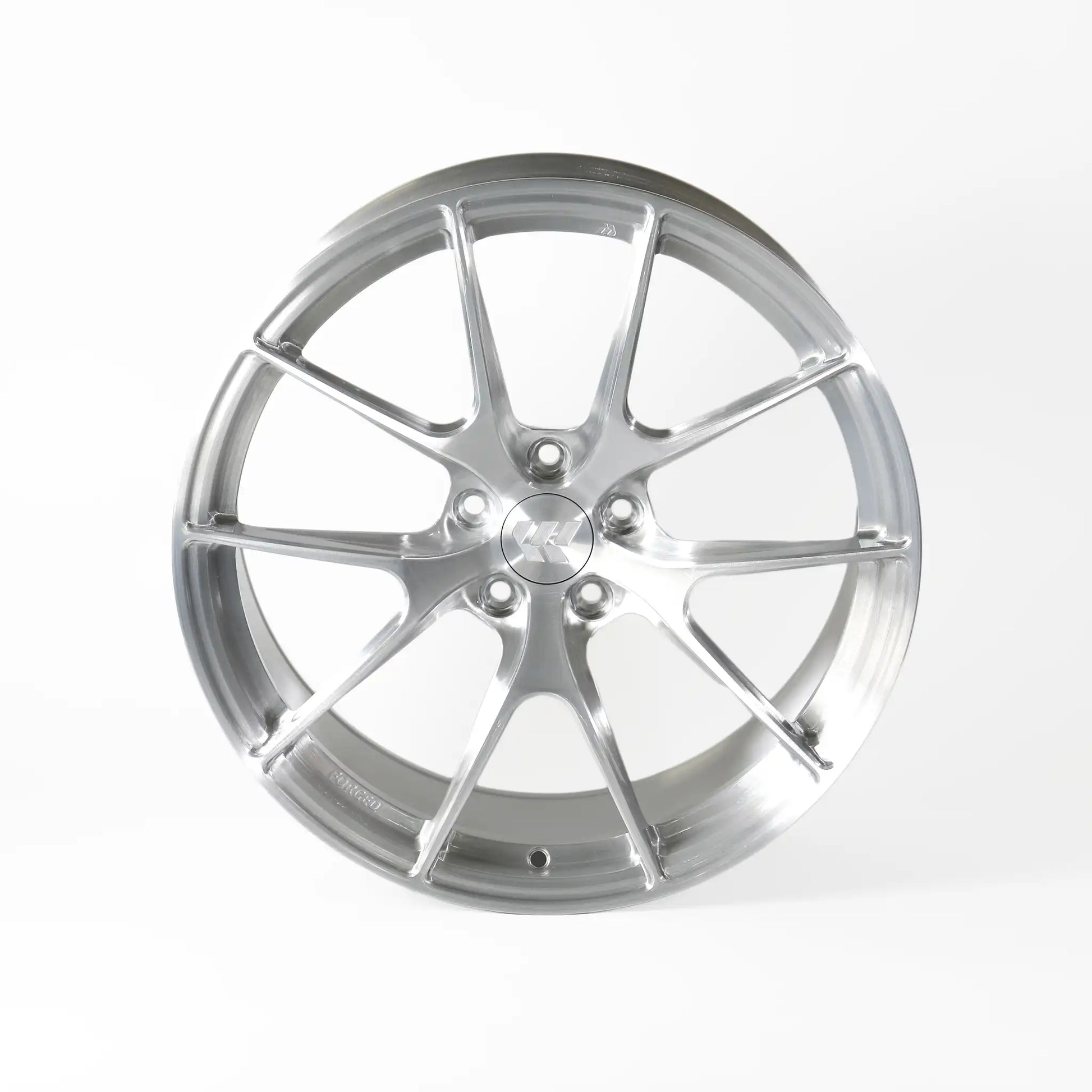 A polished silver multi-spoke alloy wheel rim, photographed from a front-three-quarter angle on a clean white studio background.