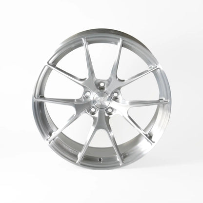 A polished silver multi-spoke alloy wheel rim, photographed from a front-three-quarter angle on a clean white studio background.