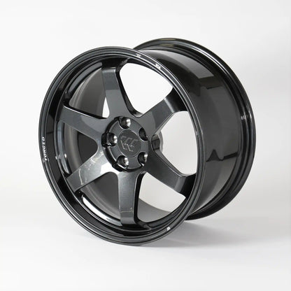 A glossy black multi-spoke alloy wheel rim, photographed at a three-quarter angle on a clean white studio background.