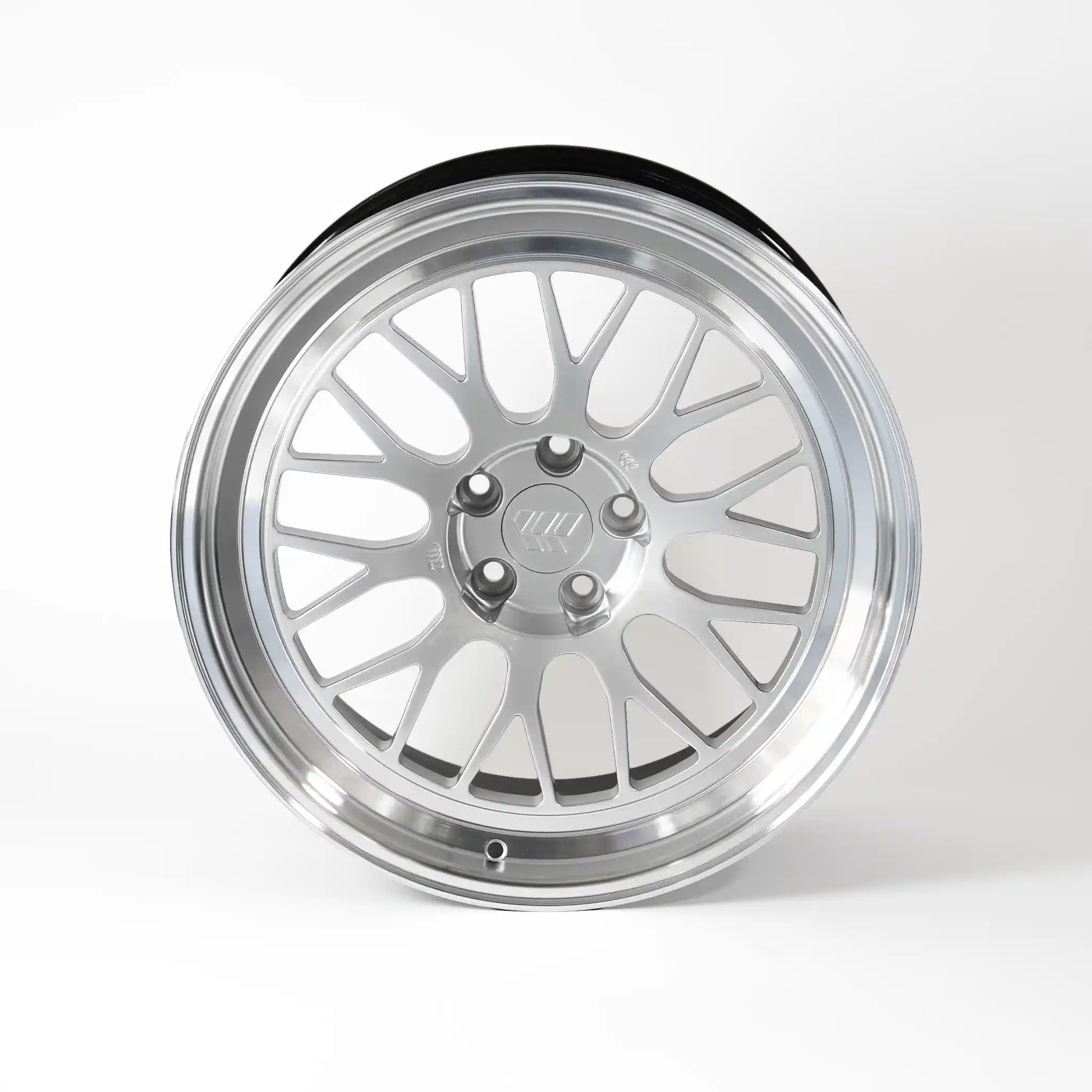 A polished silver multi-spoke alloy wheel rim with a black outer tire bead, shown from a front-three-quarter angle on a light gray background.