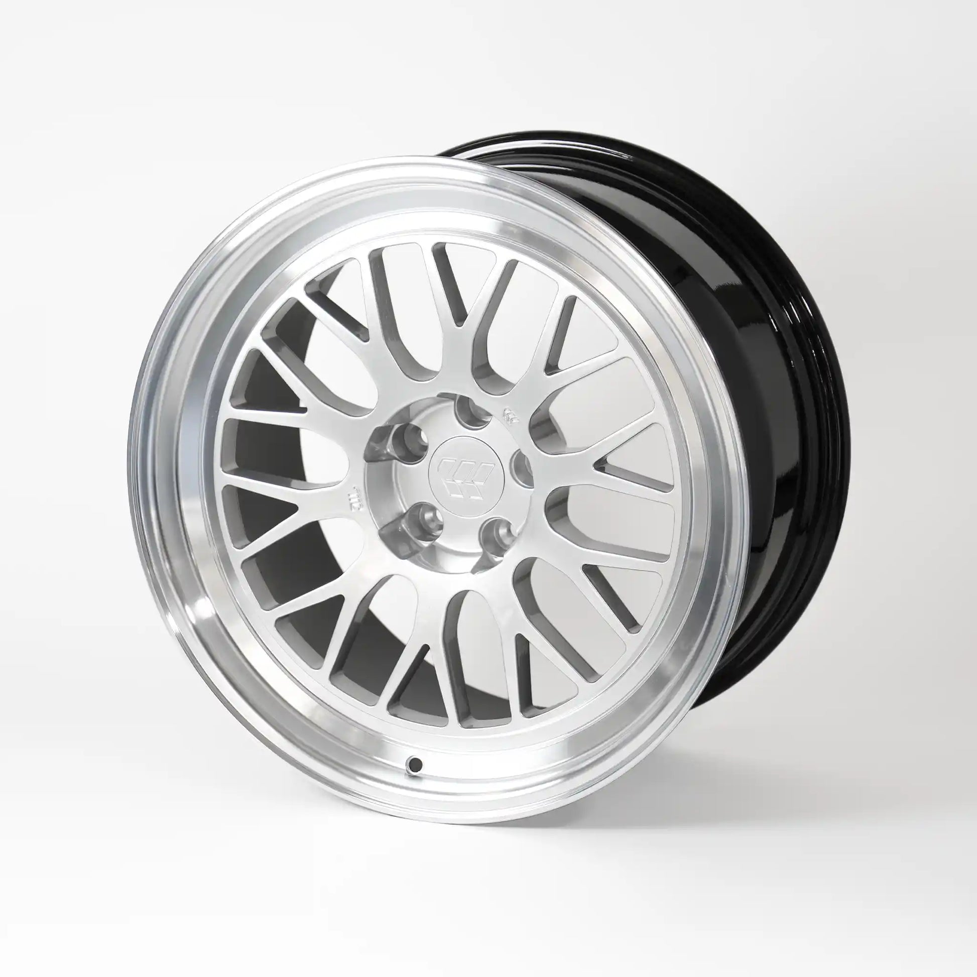 A multi-spoke alloy wheel rim with a polished silver face and a glossy black rear lip, shown on a clean white studio background.