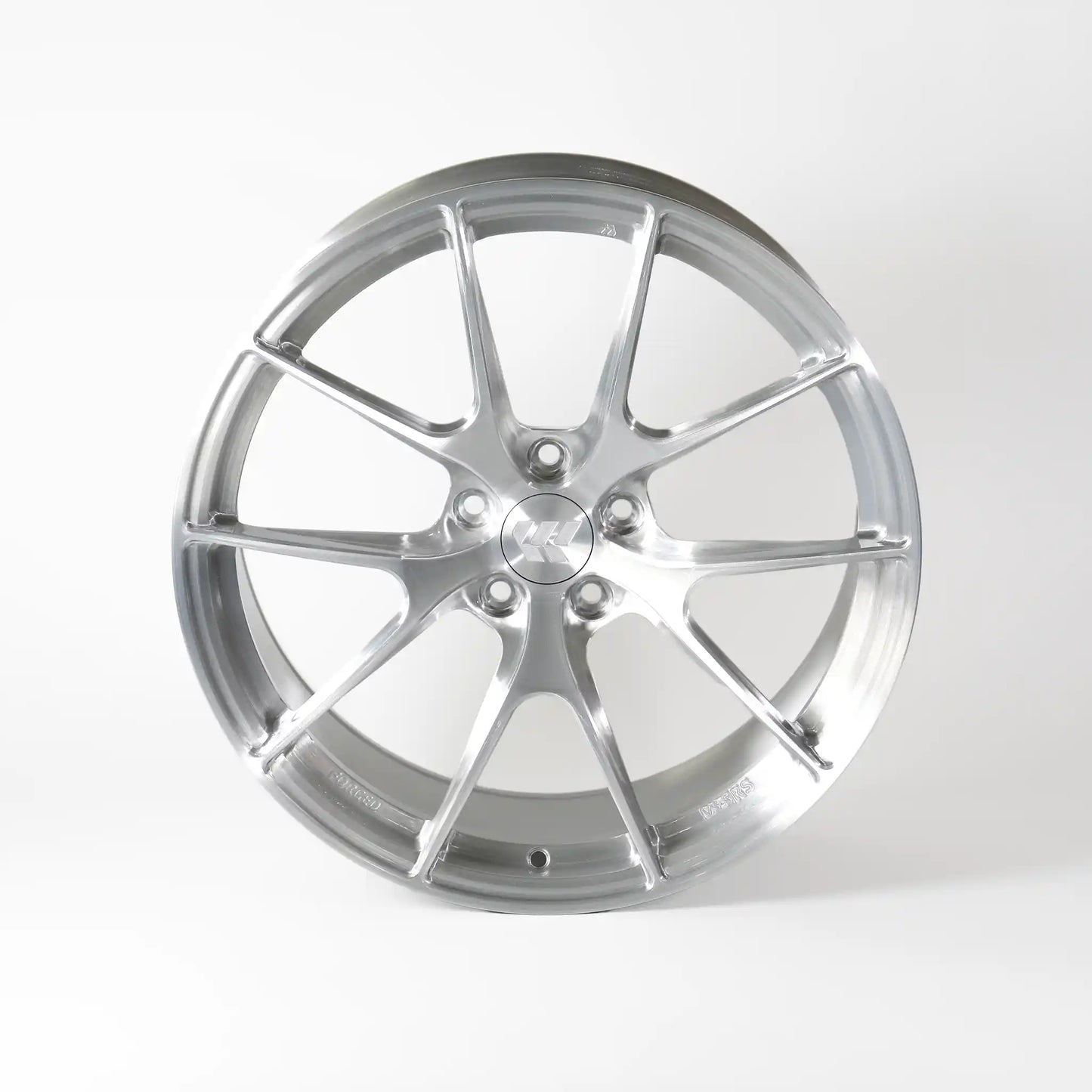 A polished silver multi-spoke alloy wheel rim, photographed from a front-three-quarter angle on a clean white studio background.