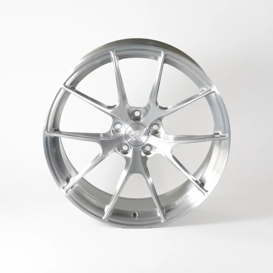 A polished silver multi-spoke alloy wheel rim, photographed from a front-three-quarter angle on a clean white studio background.